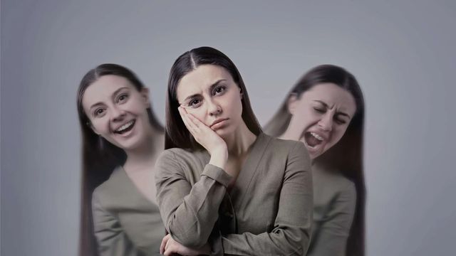 A woman resting her cheek on her hand, with blurred images of herself laughing and shouting behind